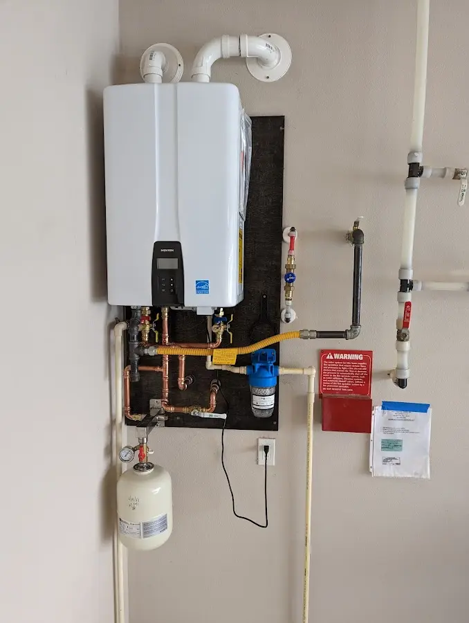 Professional plumber installing copper piping in a Effingham home